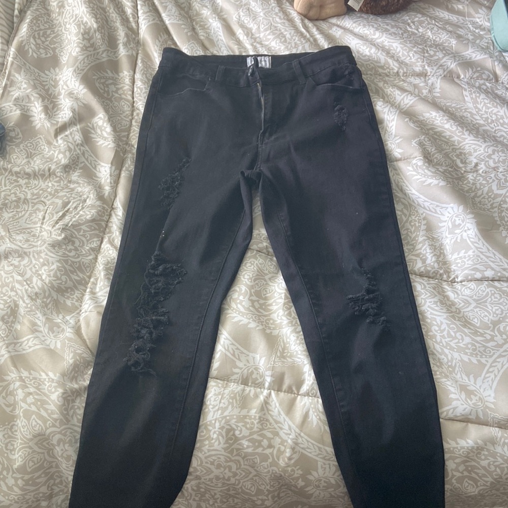 Black jeans with distressed holes.